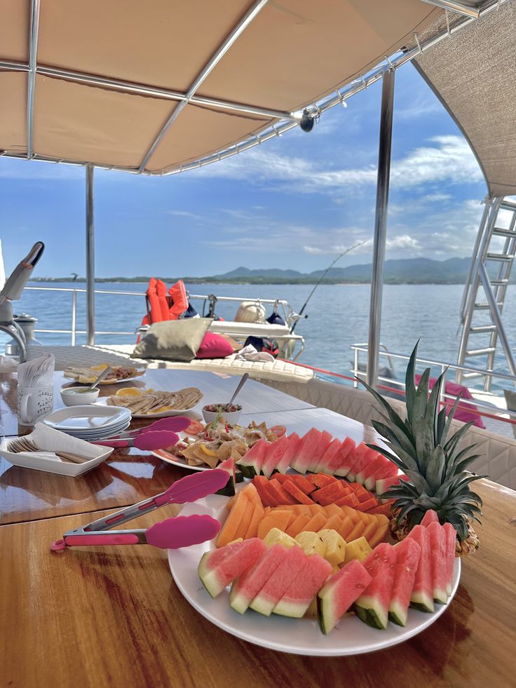 Fresh fruit and a meal served aboard a boat