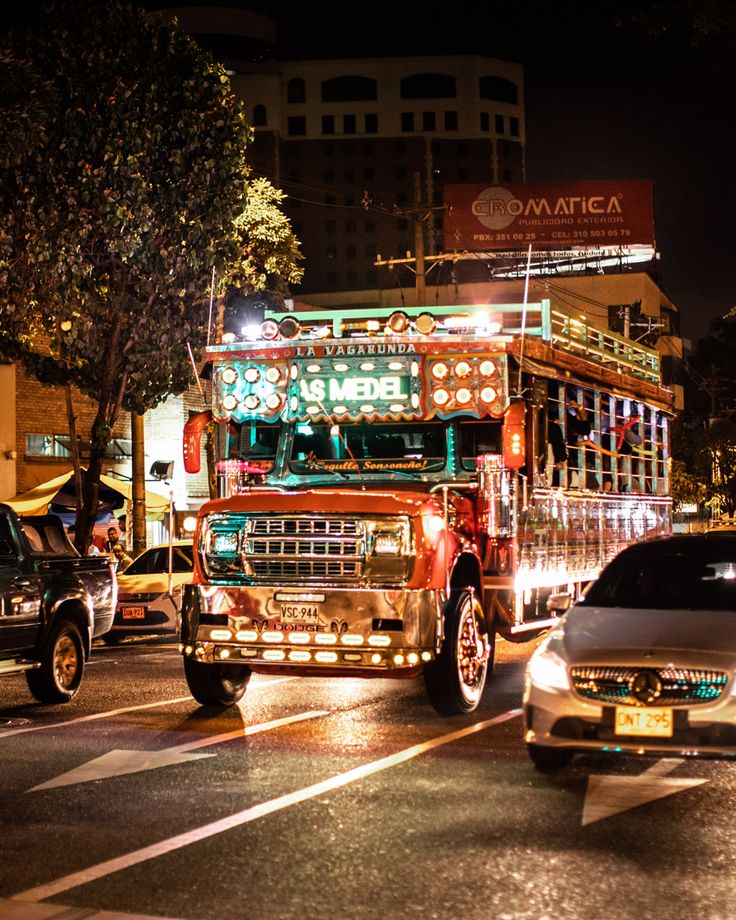 Colorfully lit chiva party bus in Medellín at night
