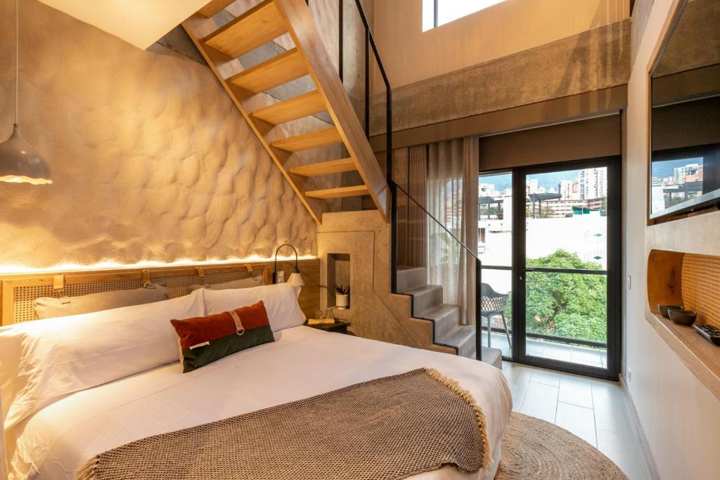 One-bed hotel room with a staircase to the upper level